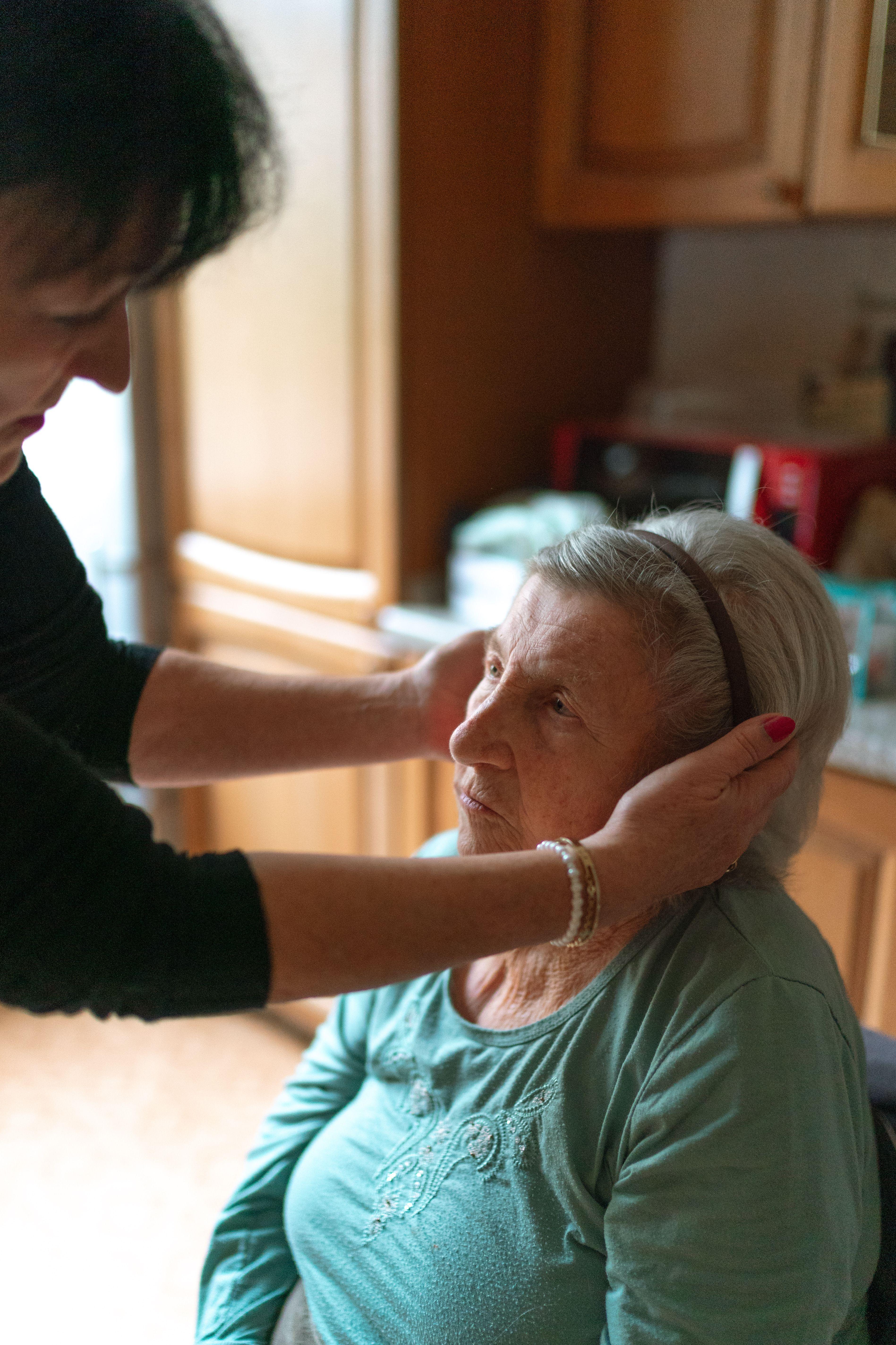 Caregiver supporting an older adult in a warm home setting